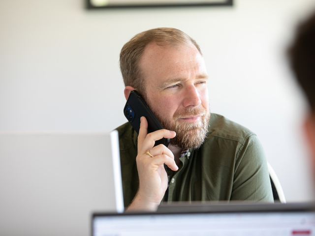 Man on phone at business recruitment desk