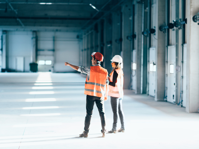 site managers oversee a new warehouse project